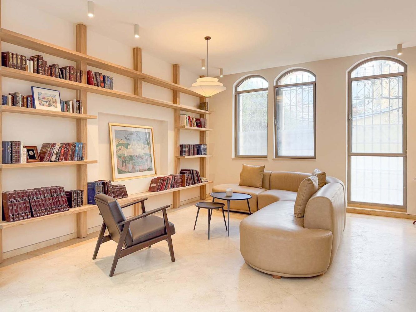 Arched windows and a library wall in a City Centre apartment
