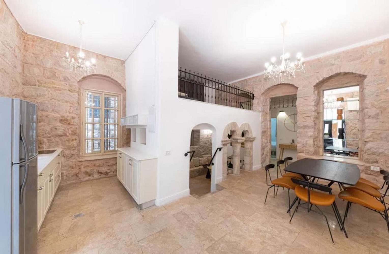 Stone arches and chandeliers in a heritage family home